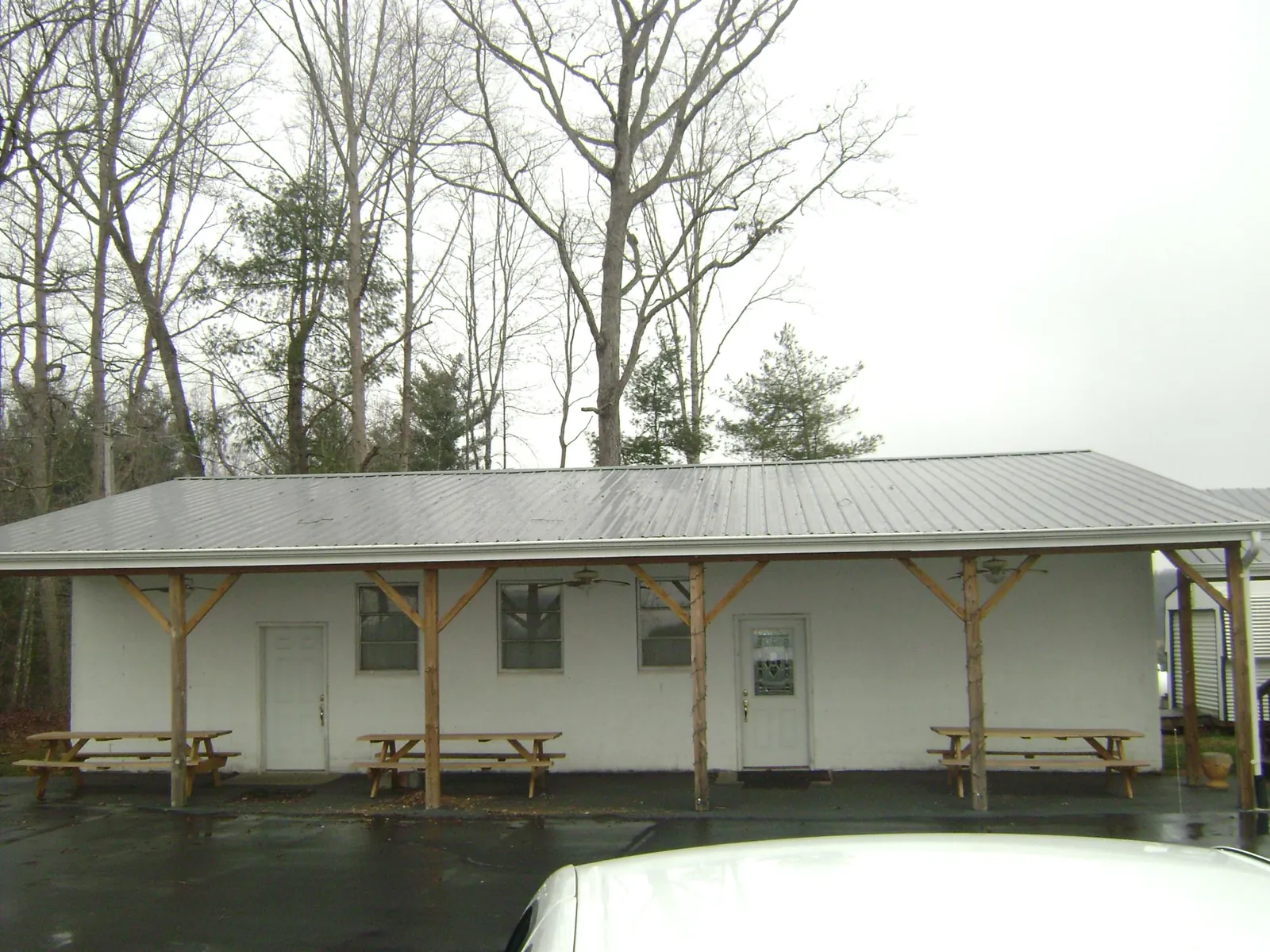 Gray metal roof over a block building with a timber post porch in Ridgeway
